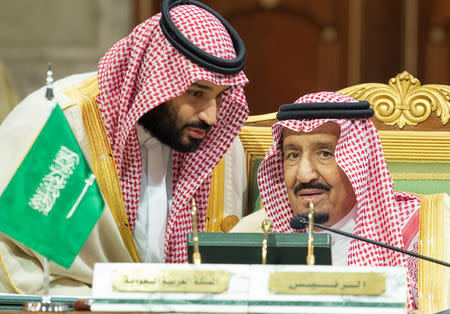 FILE PHOTO: Saudi Arabia's Crown Prince Mohammed bin Salman talks with Saudi Arabia's King Salman bin Abdulaziz Al Saud during the Gulf Cooperation Council's (GCC) Summit in Riyadh, Saudi Arabia Dec. 9, 2018. Bandar Algaloud/Courtesy of Saudi Royal Court/Handout via REUTERS/File Photo