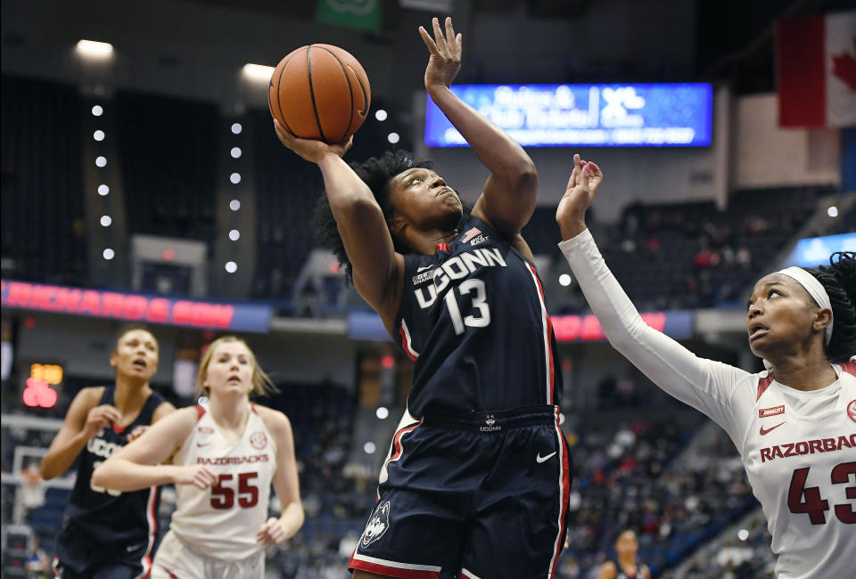 Connecticut's Christyn Williams shoots against Arkansas' Makayla Daniels (43) in the first half of an NCAA college basketball game, Sunday, Nov. 14, 2021, in Hartford, Conn. (AP Photo/Jessica Hill)