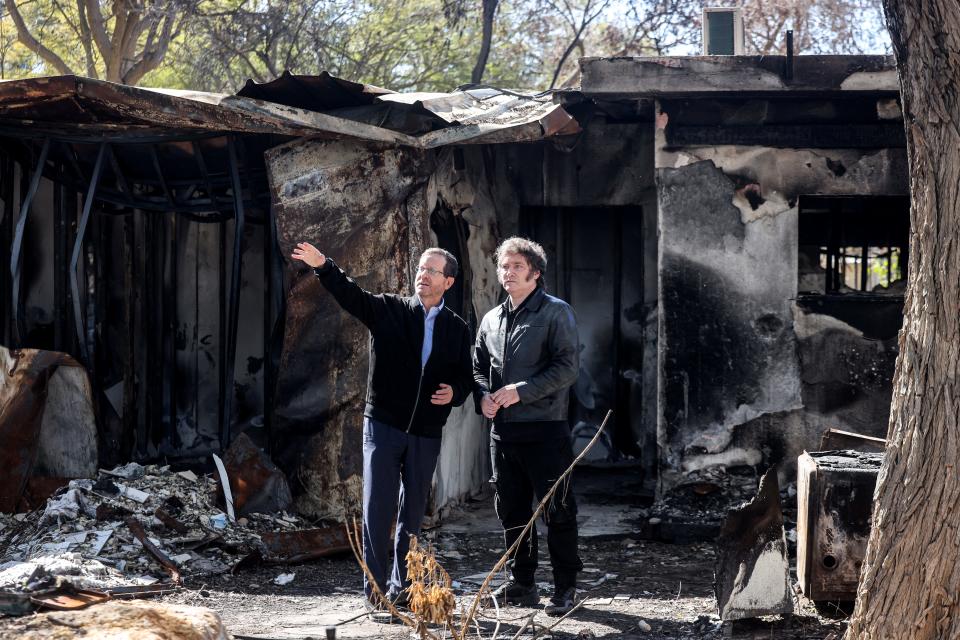 Argentine President Javier Milei tours Kibbutz Nir Oz, one of the places targeted by Hamas in the Oct. 7 attacks, with Israeli President Isaac Herzog on Feb. 8, 2024.