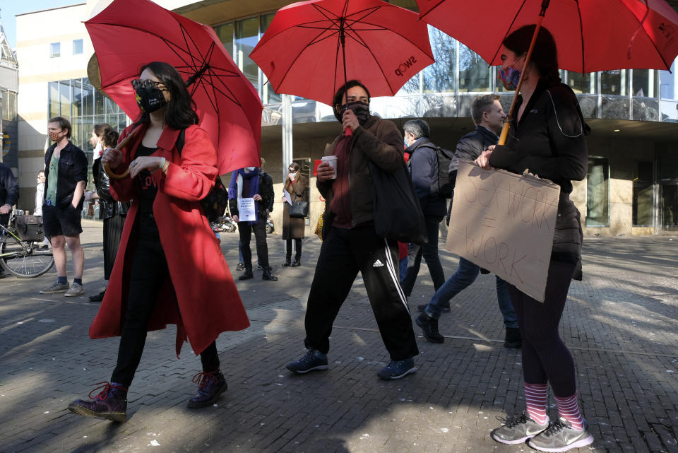 Sex workers protest against unequal treatment and stigmatizing during a demonstration in The Hague, Netherlands, Tuesday, March 2, 2021. Stores in one village opened briefly, cafe owners across the Netherlands were putting tables and chairs on their outdoor terraces and sex workers demonstrated outside parliament in protests against the government's tough coronavirus lockdown. (AP Photo/Patrick Post)