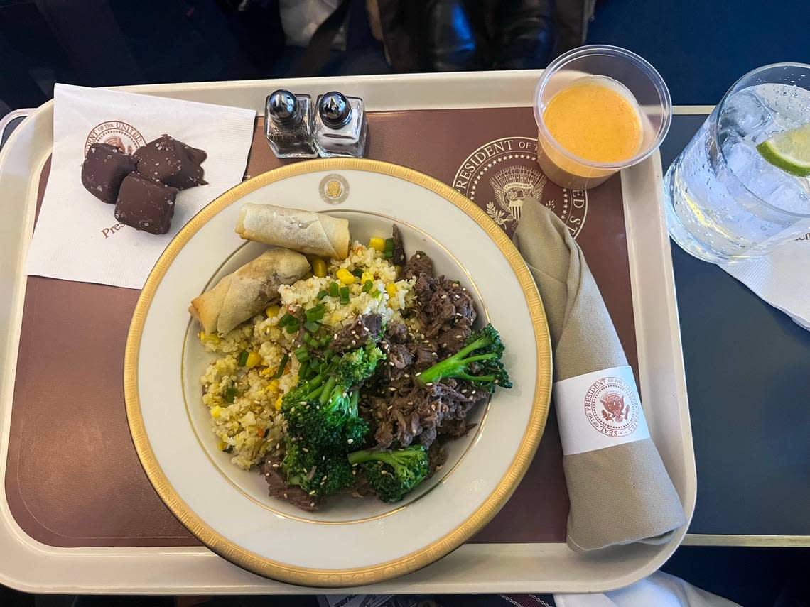 Dinner is served aboard Air Force One. The menu included beef with broccoli, fried rice, vegetable rolls and chocolates with caramel.