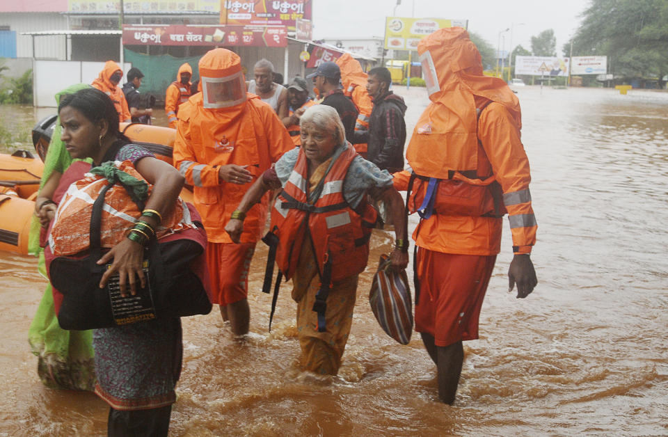 National Disaster Response Force personnel rescue people stranded in floodwaters in Kolhapur, in the western Indian state of Maharashtra, Friday, July 23, 2021. Landslides triggered by heavy monsoon rains hit parts of western India, killing at least 32 people and leading to the overnight rescue of more than 1,000 other people trapped by floodwaters, officials said Friday. (AP Photo)