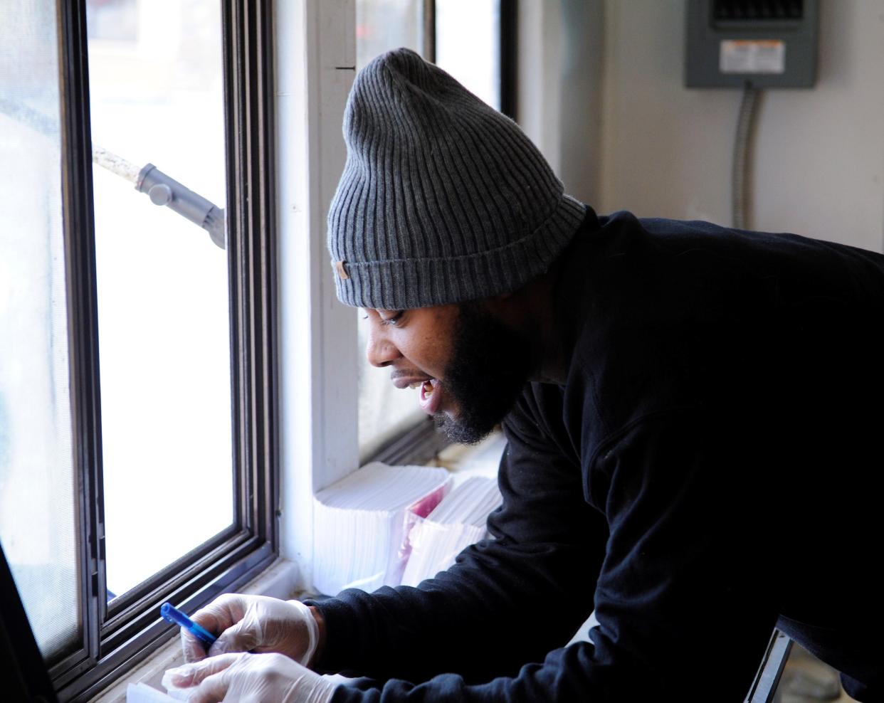 Tommy Boyd Jr. takes an order inside his Lee's Phillies and More truck on Friday, Jan. 28, 2023.