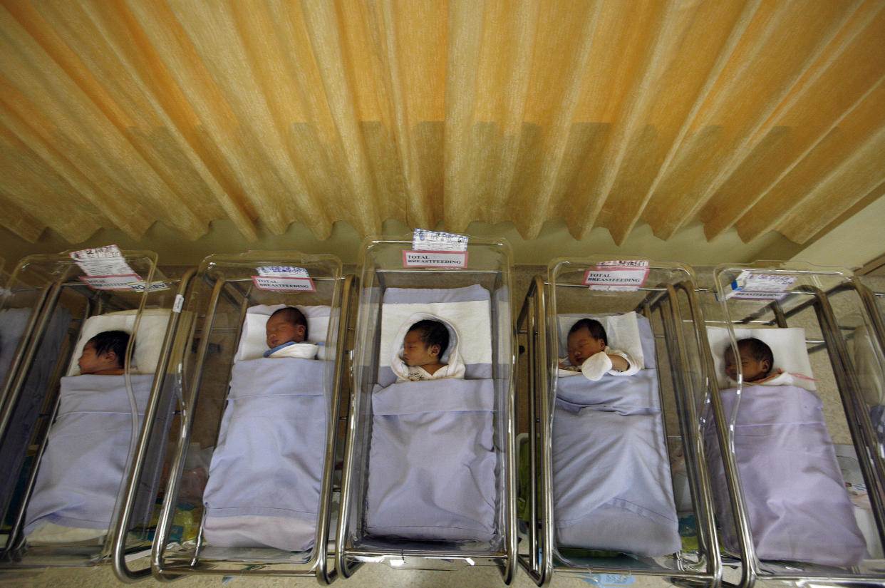 Babies lie in cots at a maternity ward in Singapore. 