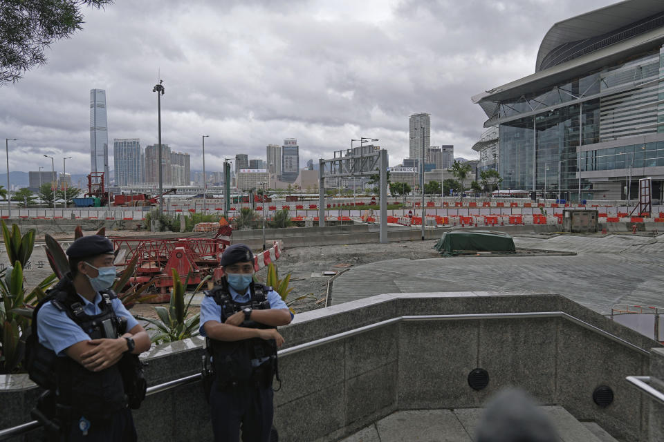 Police officers stand guard near the Convention and Exhibition Center, where Chinese President Xi Jinping will attend an inauguration ceremony for the new, sixth term government in Hong Kong, Friday, July 1, 2022. Hong Kong’s incoming and outgoing leaders attended a flag-raising ceremony Friday marking the 25th anniversary of the return to Chinese rule for the city pulled in recent years under much tighter Communist Party control. (AP Photo/Harry Long)