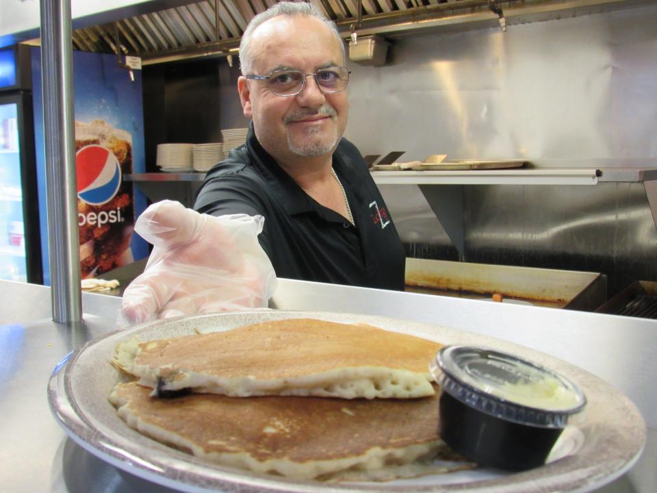 Mentor "Tony" Rama serves up house-made buttermilk pancakes at Zorba's Diner.