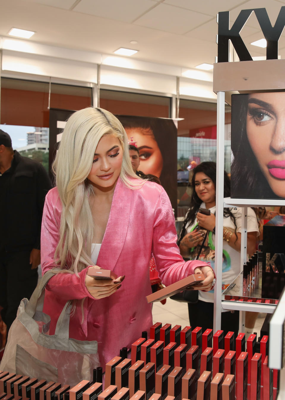 Kylie Jenner checks out her product at a beauty store. Photo: Getty