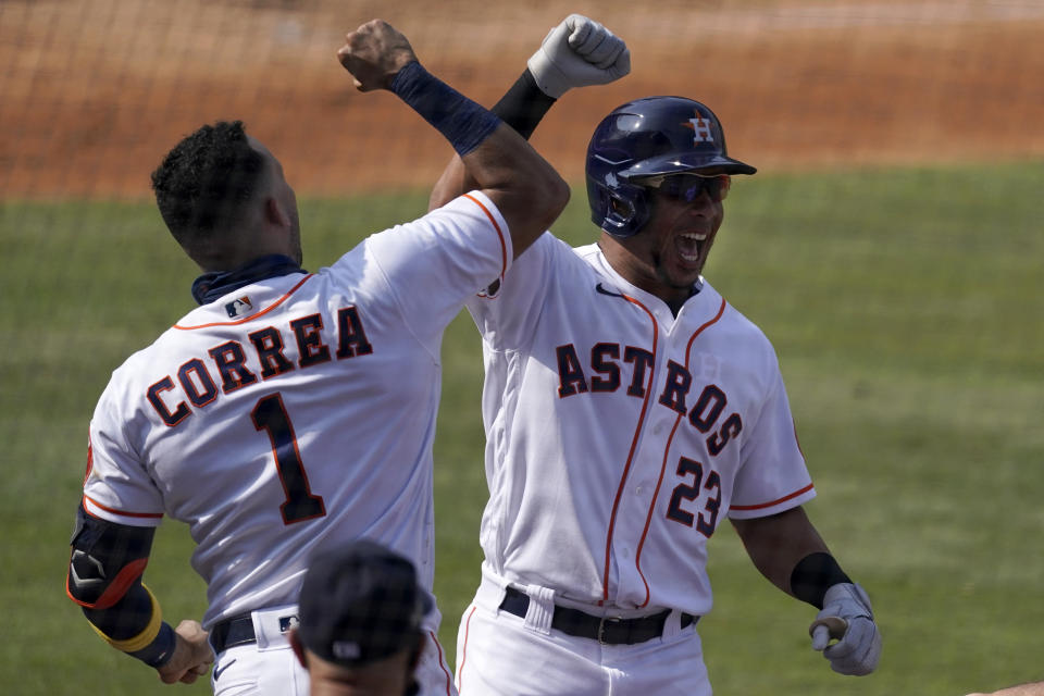 Houston Astros' Michael Brantley (23) celebrates with Carlos Correa after hitting a solo home run against the Oakland Athletics during the fifth inning of Game 4 of a baseball American League Division Series in Los Angeles, Thursday, Oct. 8, 2020. (AP Photo/Ashley Landis)