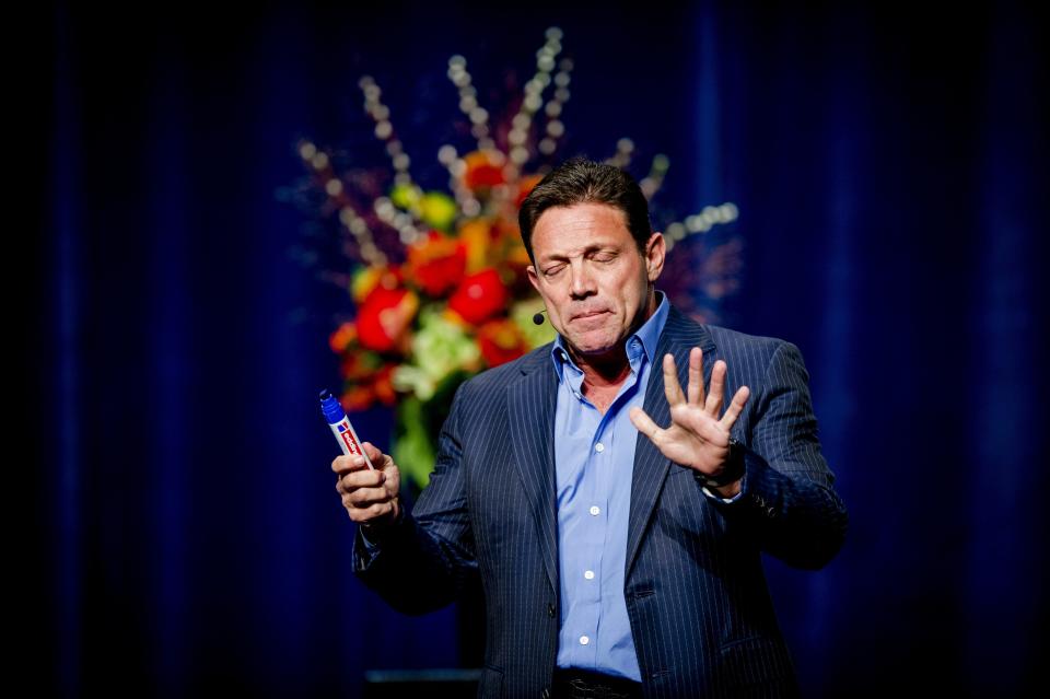 crypto Former Wall Steet player turned novelist Jordan Belfort, author of The Wolf of Wall Street which was adapted into a film by Martin Scorsese in 2013, gestures during a performance in the Rai, in Amsterdam, on November 20, 2014. AFP PHOTO/ ANP / ROBIN VAN LONKHUIJSEN Netherlands out        (Photo credit should read ROBIN VAN LONKHUIJSEN/AFP via Getty Images)