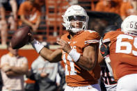 Texas quarterback Casey Thompson (11) looks to pass against Oklahoma State during the first half of an NCAA college football game in Austin, Texas, Saturday, Oct. 16, 2021. (AP Photo/Chuck Burton)