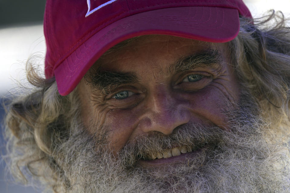 Australian Timothy Lyndsay Shaddock smiles as he speaks during a welcoming ceremony by Grupo Mar after being rescued from sea and arriving to port in Manzanillo, Mexico, Tuesday, July 18, 2023. After being adrift with his dog for three months, the pair were rescued by the Mexican tuna boat "Maria Delia," owned by Grupo Mar, from his incapacitated catamaran in the Pacific Ocean some 1,200 miles from land. (AP Photo/Fernando Llano)