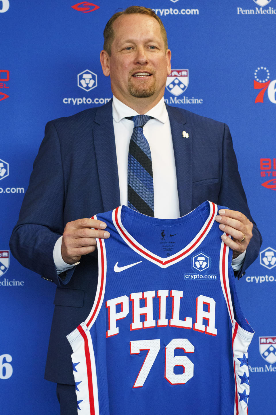 Philadelphia 76ers head coach Nick Nurse holds up a jersey after taking questions from the media during a press conference at the NBA basketball team's facility, Thursday, June 1, 2023, in Camden, N.J. (AP Photo/Chris Szagola)