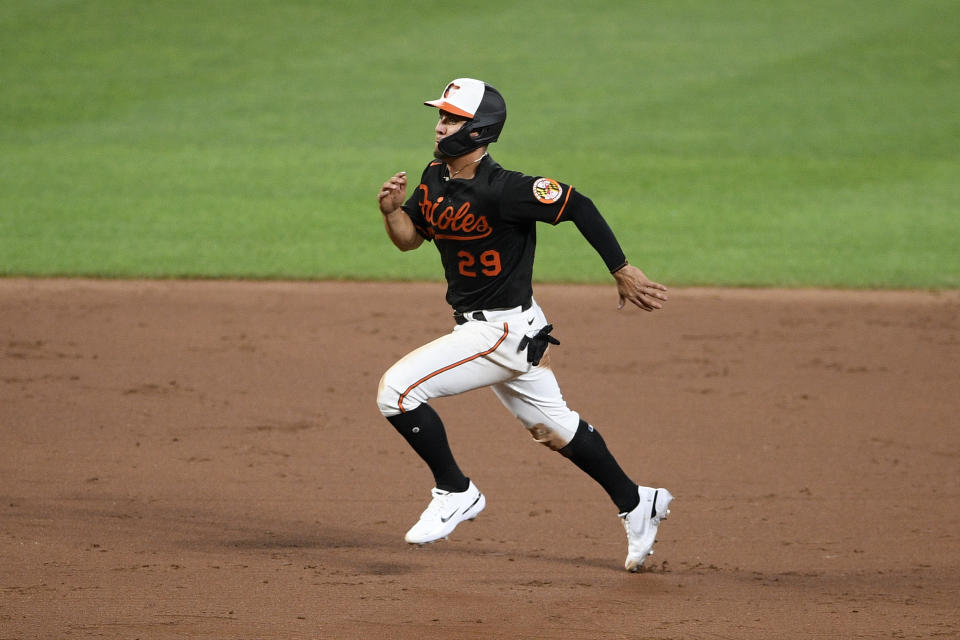 Baltimore Orioles' Ramon Urias runs to third on a throwing error by Washington Nationals relief pitcher Wander Suero on a pickoff attempt during the sixth inning of a baseball game Friday, July 23, 2021, in Baltimore. (AP Photo/Nick Wass)