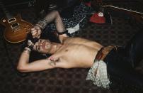 <p>Slash, the guitarist for Guns N' Roses, lays down shirtless backstage after the band's show at The Troubadour in Los Angeles. The Troubadour is known for giving bands their break, with everyone from Joni Mitchell to The Byrds performing there at some point. </p>