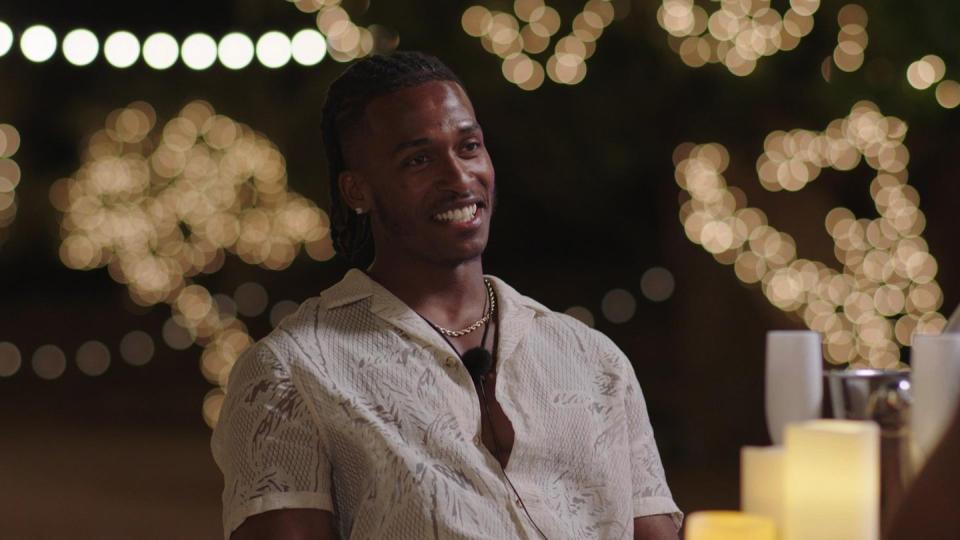 love island's omar smiles while talking to mimii on a date, in a scene from episode 7 of the summer 2024 series