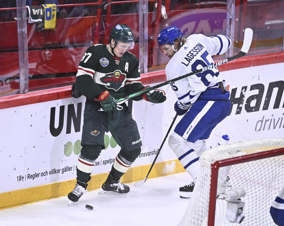 Minnesota's Kirill Kaprizov, left, and Toronto's William Lagesson in action during the NHL Global Series Sweden ice hockey match between Toronto Maple Leafs and Minnesota Wild at Avicii Arena in Stockholm, Sweden, Sunday Nov. 19, 2023. (Claudio Bresciani/TT via AP)