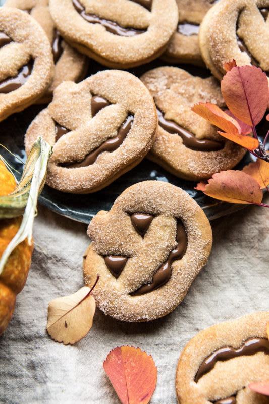 <p>Half Baked Harvest</p><p>Sweet milk chocolate, sandwiched between spiced brown sugar cookies, and finished with a light dusting of cinnamon sugar. Perfect for both a spooky Halloween night.</p><p><strong>Get the recipe: <a href="https://www.halfbakedharvest.com/milk-chocolate-stuffed-jack-o-lantern-cookies/" rel="nofollow noopener" target="_blank" data-ylk="slk:Milk Chocolate Stuffed Jack-O'-Lantern Cookies;elm:context_link;itc:0;sec:content-canvas" class="link ">Milk Chocolate Stuffed Jack-O'-Lantern Cookies</a></strong></p><p><strong>Related: </strong><strong><a href="https://parade.com/512000/lindsaylowe/17-fun-easy-couples-halloween-costume-ideas/" rel="nofollow noopener" target="_blank" data-ylk="slk:17 Fun, Easy Couples Costume Ideas;elm:context_link;itc:0;sec:content-canvas" class="link ">17 Fun, Easy Couples Costume Ideas</a></strong></p>