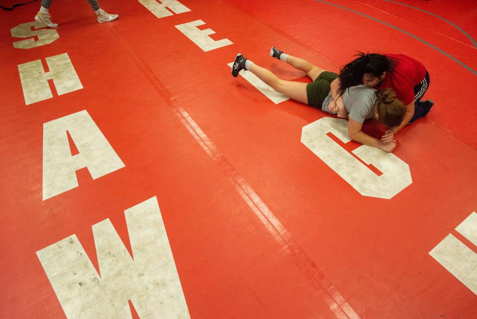 Shawnee Heights seniors Miranda Bell, in red, practices wrestling techniques with Taryn Dial on Wednesday morning.