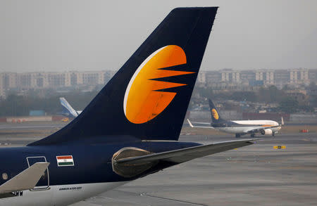 FILE PHOTO: A Jet Airways plane is parked as other moves to runway at the Chhatrapati Shivaji International airport in Mumbai, India, February 14, 2018. REUTERS/Danish Siddiqui/File Photo