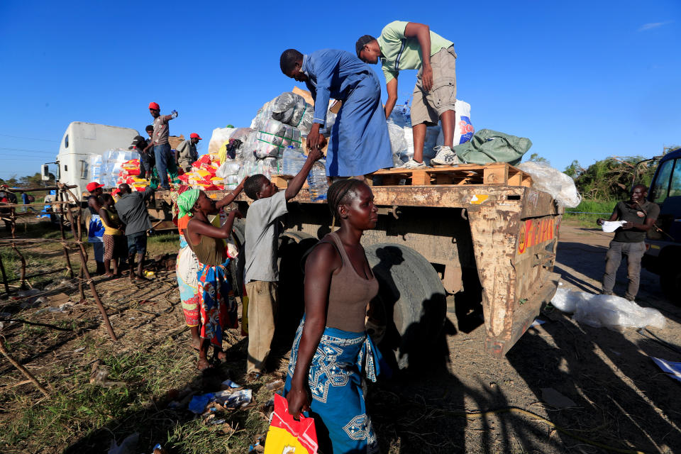 Maria Jofresse, 25, carries aid packages at a camp for the displaced in the aftermath of Cyclone Idai, in John Segredo, near Beira, Mozambique April 2, 2019. (Photo: Zohra Bensemra/Reuters)  