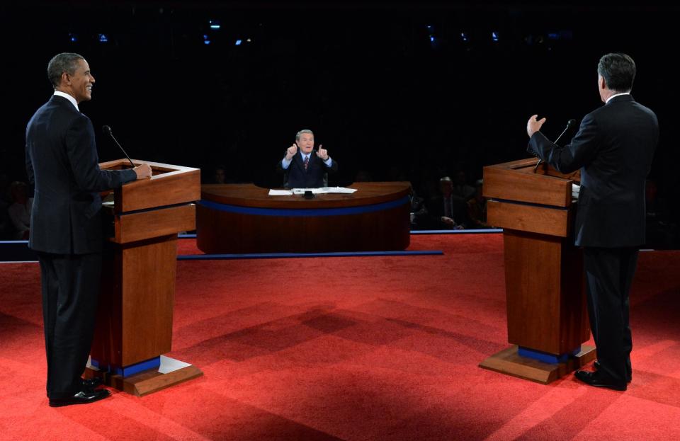 President Barack Obama and Republican presidential nominee Mitt Romney listen to a question from moderator Jim Lehrer during the first presidential debate at the University of Denver, Wednesday, Oct. 3, 2012, in Denver. (AP Photo/Pool-Michael Reynolds)