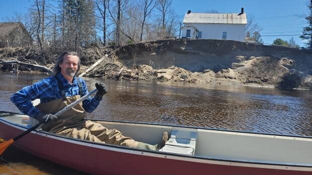 Bruce Hughes worries his house will fall into the Keswick River within the next few rainfalls. He's pleaded with government to help save his home, but says he was told it wasn't a priority. (Shane Fowler/CBC News - image credit)