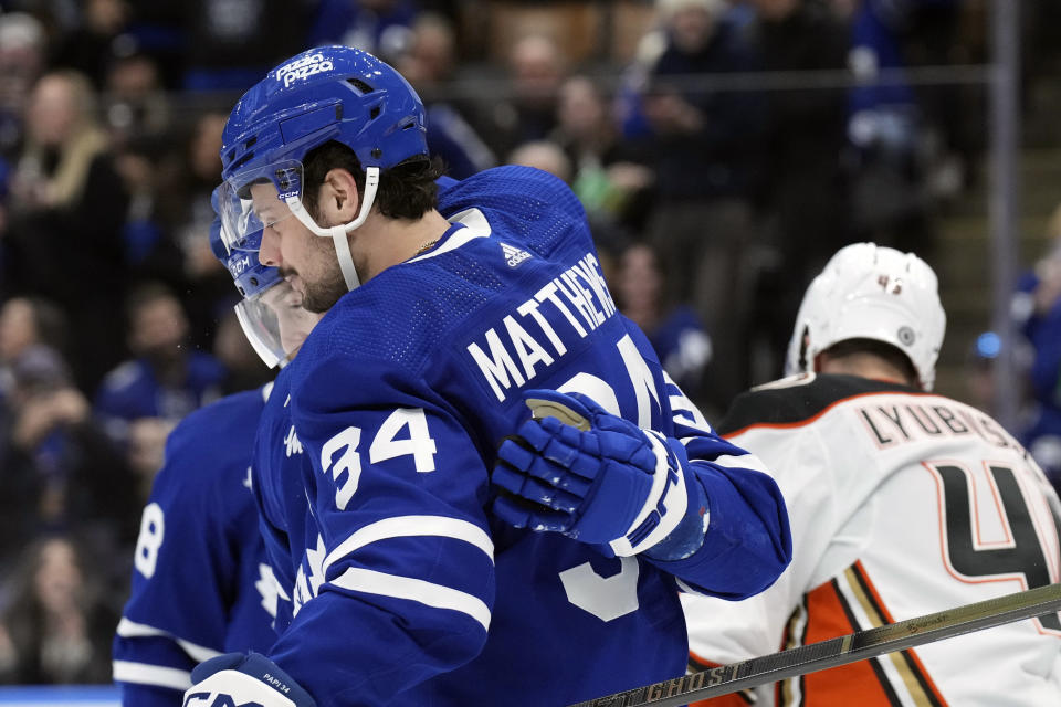 Toronto Maple Leafs' Auston Matthews congratulates Tyler Bertuzzi after scoring against the Anaheim Ducks during the second period of an NHL hockey game, Saturday, Feb. 17, 2024 in Toronto. (Chris Young/The Canadian Press via AP)