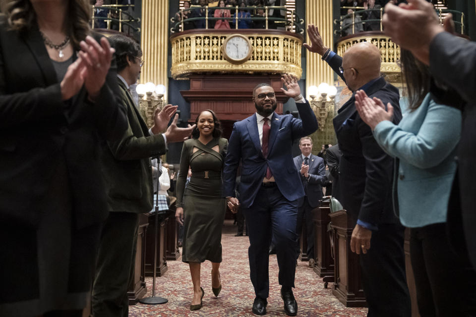 Austin Davis accompanied by his wife Blayre Holmes Davis arrive in the Senate chambers to become Pennsylvania's first Black lieutenant governor, during a ceremony Tuesday, Jan. 17, 2023, at the state Capitol in Harrisburg, Pa. (AP Photo/Matt Rourke)