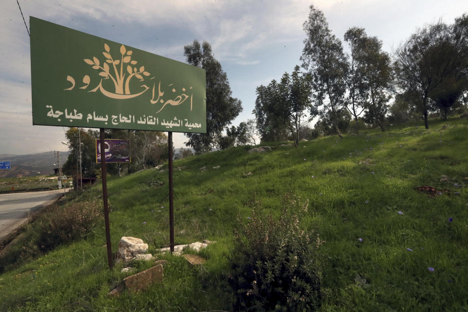 A nature reserve where trees were planted by Green Without Borders a non-governmental organization, in the outskirts of the southern town of Nabatiyeh, Lebanon, Monday, Jan. 16, 2023. Green Without Borders that is active in southern Lebanon, including areas along the border with Israel, is being blamed by Israel, the U.S. and some in Lebanon for being an arm for Hezbollah to cover some of the group's military activities. The association denies such charges. The Arabic on the board reads "Green Without Borders, reserve of martyr commander Haj Bassam Tabaja." (AP Photo/Mohammed Zaatari)