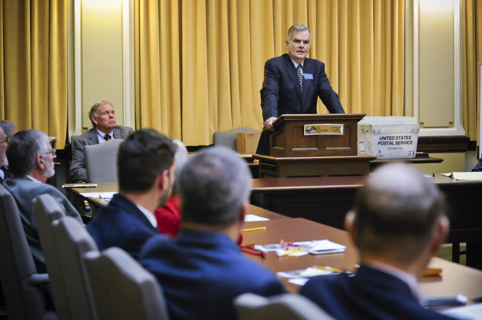 FILE - In this Nov. 14, 2018 file photo Senate President Scott Sales, R-Bozeman, addresses the Senate Republican caucus at the State Capitol in Helena, Mont. Montana's Senate president is proposing the state give more than $8 million to help build President Donald Trump's proposed wall on the Mexican border. Sales, a Republican, says his proposal is a "small token" to show border security "is of vital interest to all citizens regardless of what state they live in." (Thom Bridge/Independent Record via AP, File)