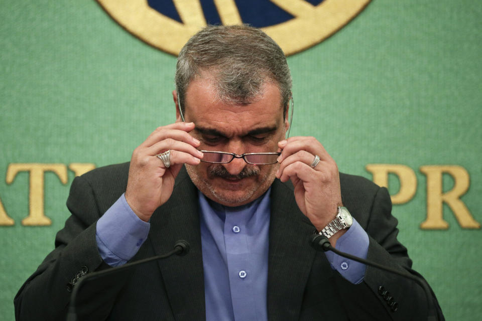 Iranian Ambassador to Japan Morteza Rahmani Movahed puts on his reading glasses before speaking at a news conference Monday, June 24, 2019, in Tokyo. He said his country faces “economic terrorism targeting Iranian people” as U.S. piles sanction after sanction on the country. (AP Photo/Jae C. Hong)