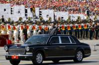 Chinese President Xi Jinping stands in a car on his way to review the army as military band members play next to him, at the beginning of the military parade marking the 70th anniversary of the end of World War Two, in Beijing, China, September 3, 2015. REUTERS/Damir Sagolj