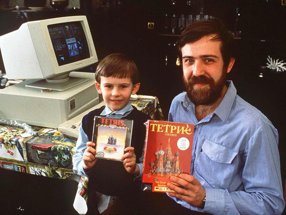 Alexey Pajitnov and one of his sons pose with copies of Tetris in 1989 (Shutterstock)