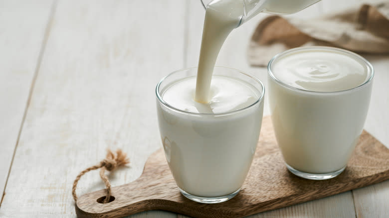 pouring homemade buttermilk into glass