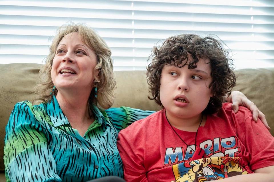 Laurel Petersen, the mother and conservator for Lance Petersen, takes a break from work to sit with Lance last month in Roseville. She seeking an increase in the child support Lance receives, and worries if she gets it, he won’t qualify for Medi-Cal.