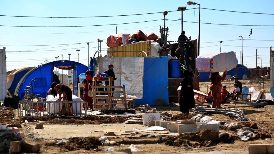 Displaced Iraqis pack up in preparation to return to their homes in Jadah 5 camp in northern Iraq, Thursday, Feb. 4, 2021. Iraq appears to have back-tracked plans to close a camp for internally-displaced Iraqis, many with links to the Islamic State, following a week of confusion and outcry from families unable to return home. (AP Photo/Farid Abdulwahed)