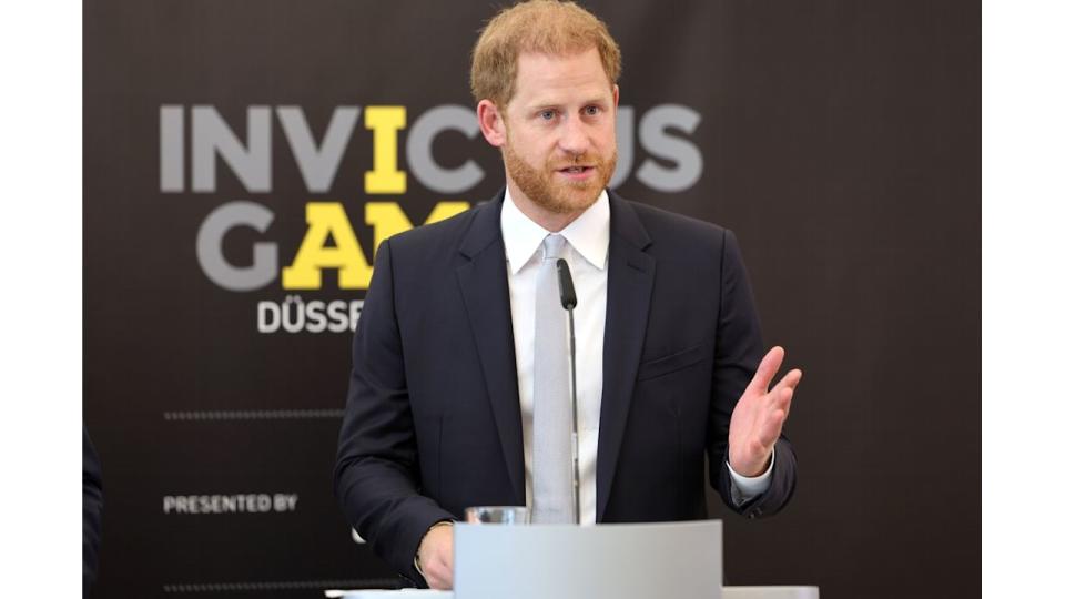 Prince Harry speaking in a black suit