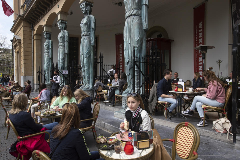 Dutch customers eager for their first drink of coffee or something stronger at a cafe terrace have flocked to outdoor seating as the Netherlands' lockdown eased in Utrecht, Wednesday, April 28, 2021. The Netherlands became the latest European country to begin cautiously relaxing its lockdown even as infection rates and intensive care occupancy remain stubbornly high. The Dutch follow Italy, Greece, France and other European nations in moving to reopen society and edge away from economically crippling lockdowns in the coming weeks.(AP Photo/Peter Dejong)