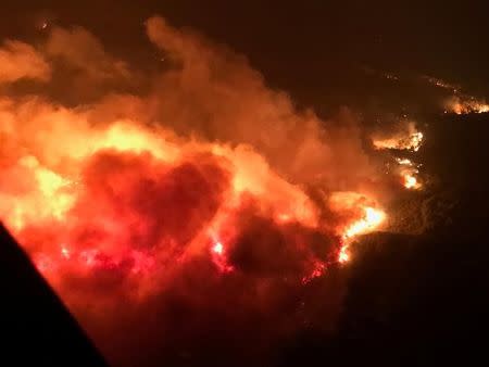 A wildfire is shown from the air near Atlas Road during an operation to rescue people trapped by wildfire in Napa, California, U.S., October 9, 2017. Courtesy California Highway Patrol/Handout via REUTERS