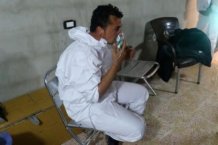 A man breathes through an oxygen mask, after what rescue workers described as a suspected gas attack in the town of Khan Sheikhoun in rebel-held Idlib, Syria April 4, 2017. REUTERS/Ammar Abdullah