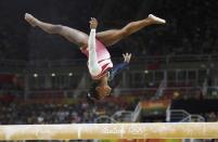 Simone Biles competes on the beam during the women's team final. REUTERS/Dylan Martinez
