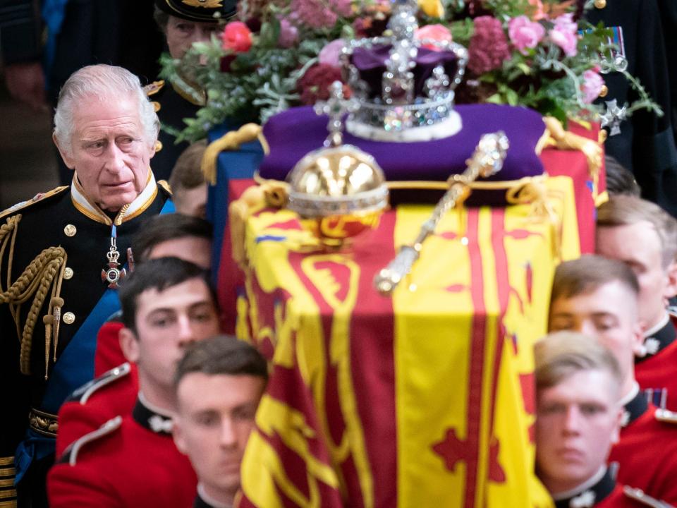 King Charles III and members of the royal family follow behind the coffin of Queen Elizabeth II, draped in the Royal Standard with the Imperial State Crown and the Sovereign's orb and sceptre, as it is carried out of Westminster Abbey after her State Funeral on September 19, 2022