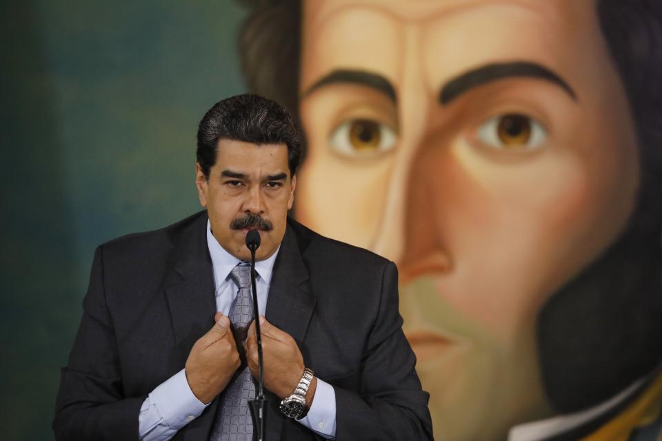 Backdropped by a painting of independence leader Simon Bolivar, Venezuela's President Nicolas Maduro gives a press conference at the Foreign Ministry in Caracas, Venezuela, Monday, Sept. 30, 2019. Maduro denied the accusation by the Colombian president that the guerrilla group ELN was operating with the Venezuelan government's support inside Venezuelan territory, answered questions about his recent trip to Russia and about a possible return to the negotiation table with the opposition. (AP Photo/Ariana Cubillos)