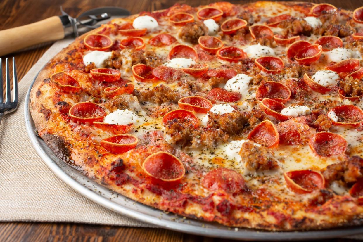 <p><br></p><p>In Buffalo, New York, the pizza has a soft, fluffy crust. It’s topped with enough cheese to guarantee an epic cheese pull, along with ample toppings. The most iconic Buffalo pizza topping is pepperoni, but instead of the thick, flat pepperoni slices you’ll usually find at New York corner slice joints, this pepperoni is smaller and cut thicker, so when it’s baked the edges curl up into little “cups” that fill up with tasty oil. This is usually referred to as “cup & char” pepperoni, or “‘roni cups.” The pizza served at Buffalo’s <a href="https://www.goldbelly.com/restaurants/picassos-pizza" rel="nofollow noopener" target="_blank" data-ylk="slk:Picasso’s Pizza;elm:context_link;itc:0;sec:content-canvas" class="link rapid-noclick-resp">Picasso’s Pizza</a> has been an icon for over 40 years.</p><span class="copyright"> Photography By Tonelson/Istockphoto </span>