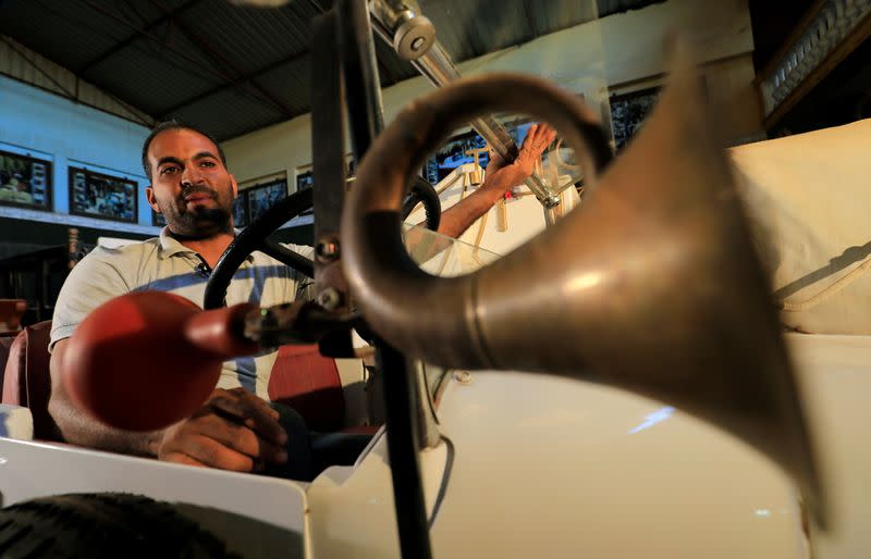 Ayman Sima, the 38-years-old son's of Sayed Sima, an Egyptian collector of vintage cars, sits on an Italian 1928 "FIAT 501" automobile at his father's store where he also has an exhibition of old cars, in the Giza suburb of Abu Rawash