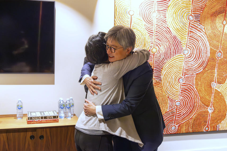 In this photo provided by the Department of Foreign Affairs and Trade, Chinese Australian journalist Cheng Lei, left, hugs Australia's Minister for Foreign Affairs, Penny Wong, at Tullamarine Airport in Melbourne, Wednesday, Oct. 11, 2023. Cheng, who was convicted on murky espionage charges and detained in China for three years has returned to Australia. (Sarah Hodges/DFAT via AP)