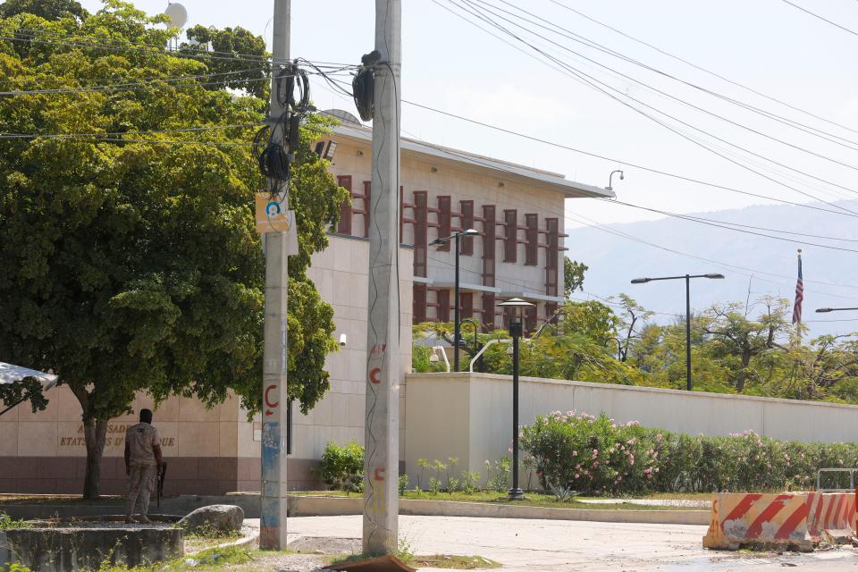 A police officer guards the entrance of the U.S. embassy in Port-au-Prince, Haiti, Sunday, March 10, 2024. The U.S. military said Sunday that it had flown in forces to enhance security at the delegation and allow nonessential personnel to leave. (AP Photo/Odelyn Joseph)