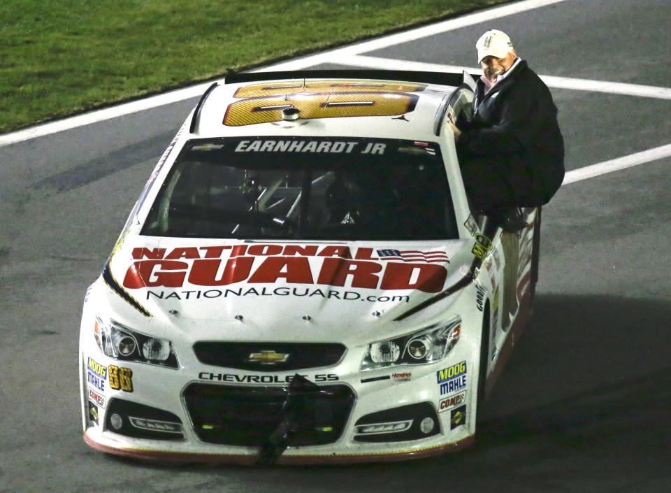 Car owner Rick Hendrick rides with Dale Earnhardt Jr. to Victory Lane as they celebrate after winning the Daytona 500 NASCAR Sprint Cup Series auto race at Daytona International Speedway in Daytona Beach, Fla., Sunday, Feb. 23, 2014. (AP Photo/John Raoux)