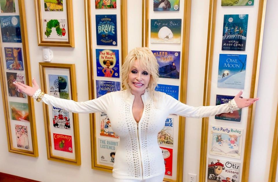 Dolly Parton, founder of Imagination Library, strikes a pose in her office.