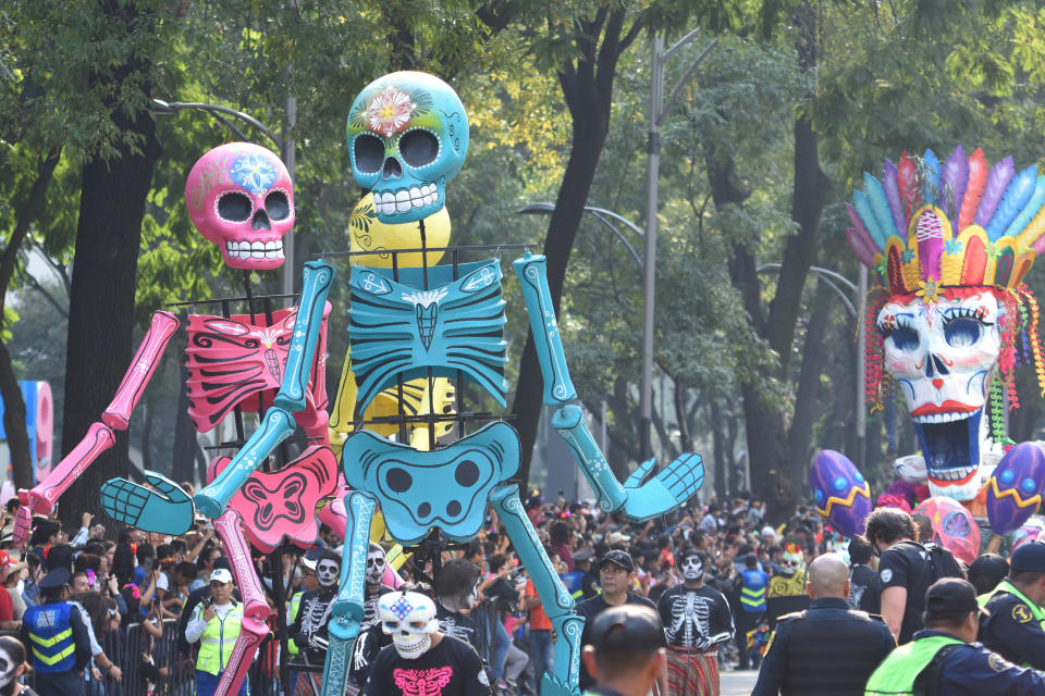 People are seen participating in Day of the Dead celebrations in Mexico City on Saturday.